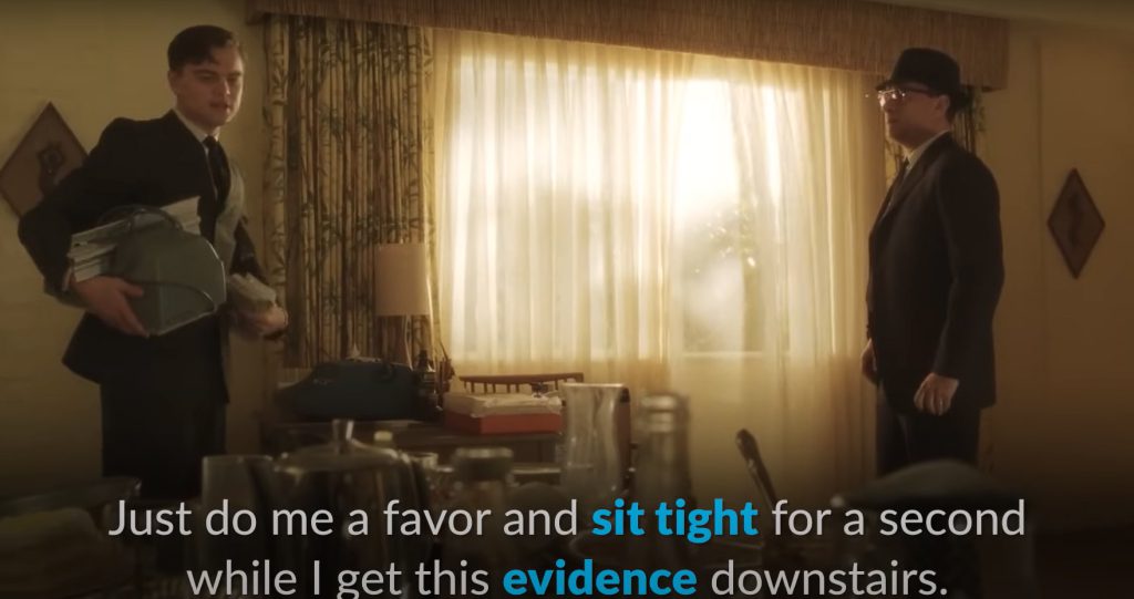 "Boost your English skills with Netflix. A cozy setup featuring 'Catch Me If You Can' on-screen, surrounded by notebooks and flashcards."