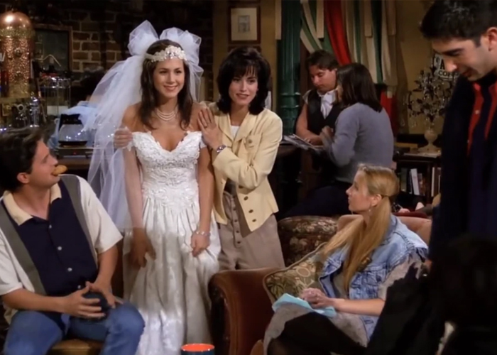  "Rachel Green in a wedding dress at Central Perk with Monica and the Friends cast in Season 1 Episode 1."