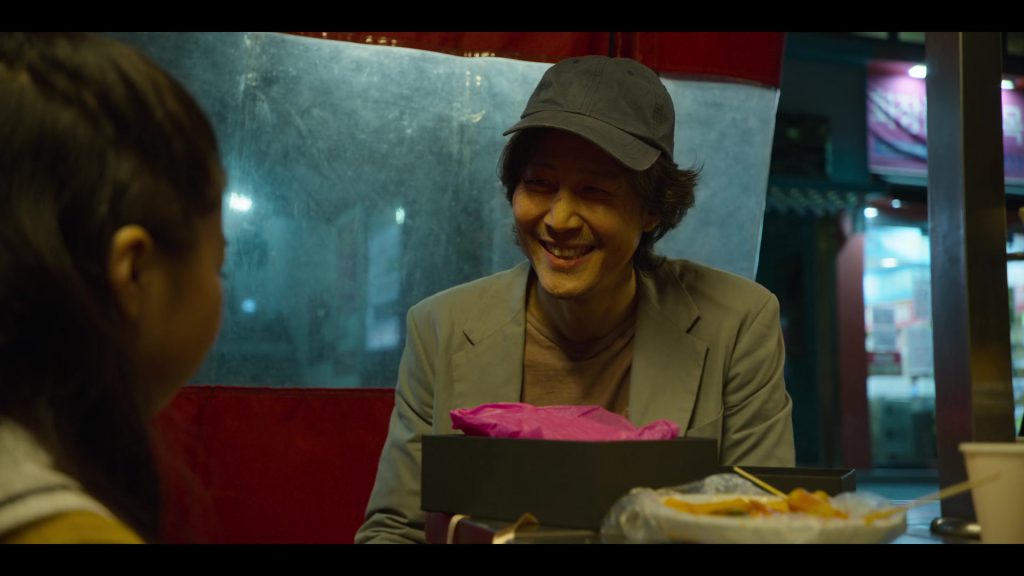 Heartwarming Moment: Gi-hun Shares Dinner with His Daughter Gi-hun sharing a heartfelt moment with his daughter in "Squid Game."