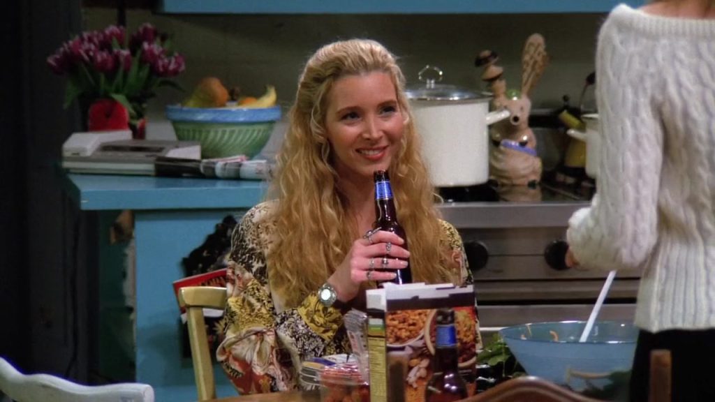 Phoebe holding a drink during a conversation in Friends S01 E14.