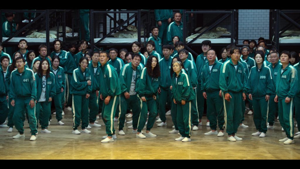 Contestants in green tracksuits during Squid Game Season 1 Episode 2.
