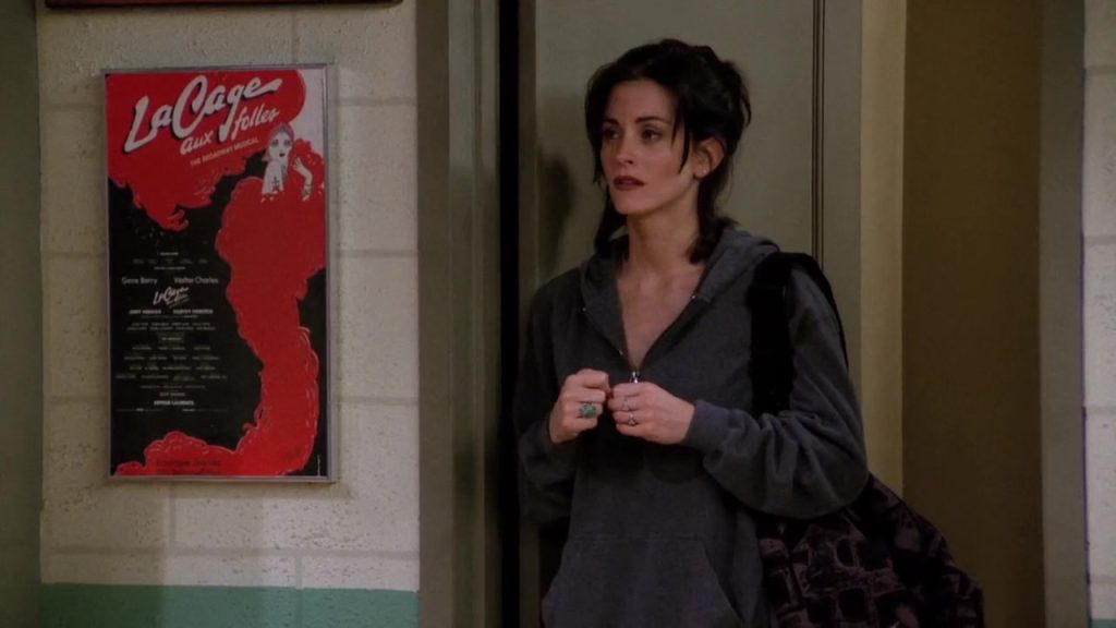 Monica looking nervous at the entrance of a dance class in Friends S01E21