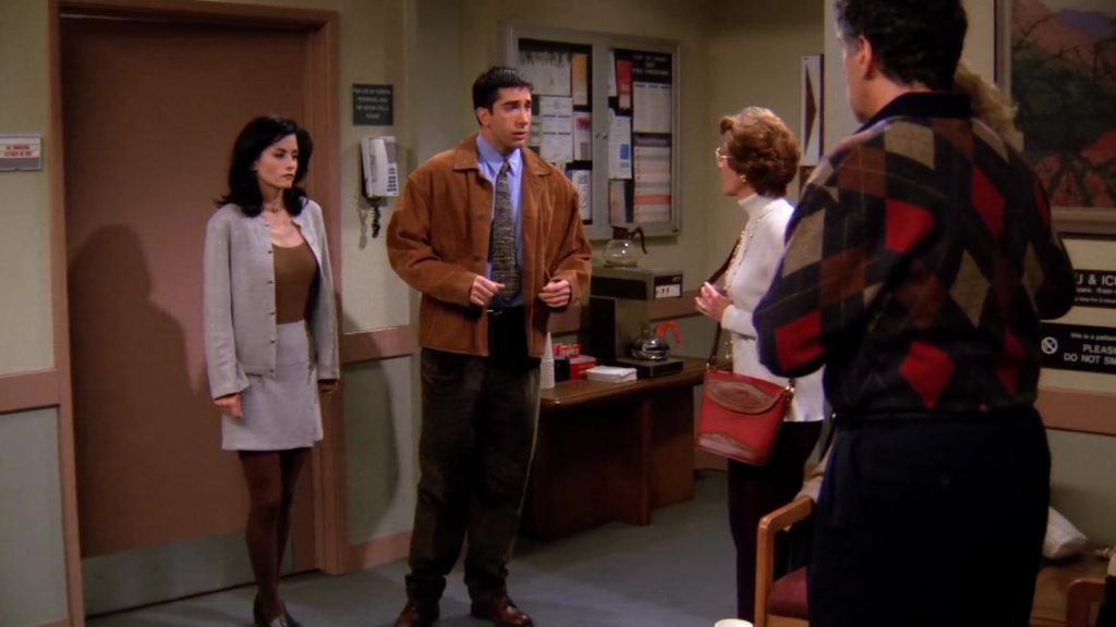 Ross and Monica with family at the hospital discussing Nana’s condition in Friends S01E08.