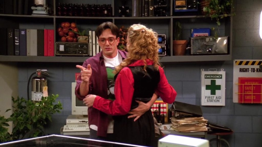 Phoebe and David in a lab, sharing a romantic moment in Friends S01E10.