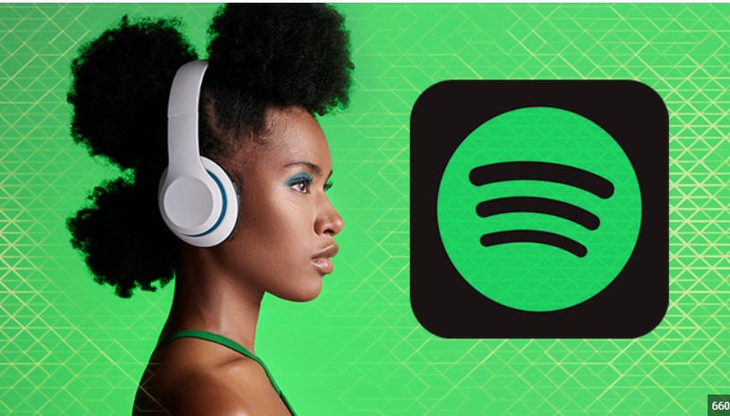  Woman with headphones, Spotify logo in the background, highlighting technology for language learning.