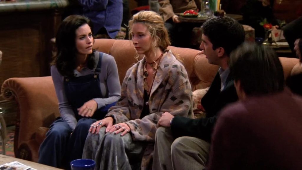 Monica, Phoebe, and Ross talking on a sofa at Central Perk.