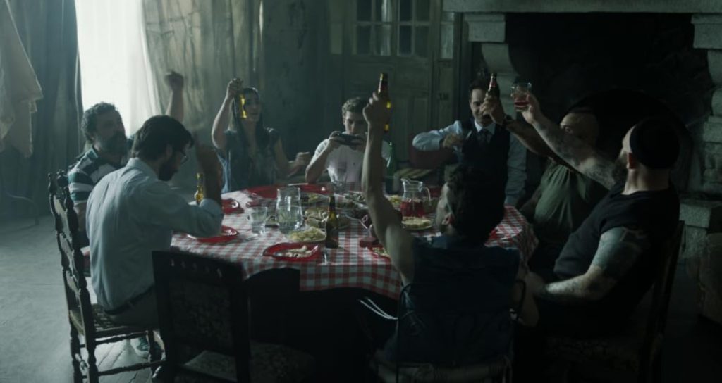 Robbers toasting at dinner table in Monet Heist for learning English via film.