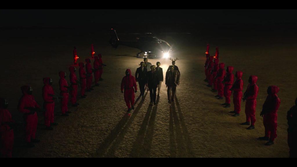 VIPs and masked guards lined up in Squad Game Episode 7.