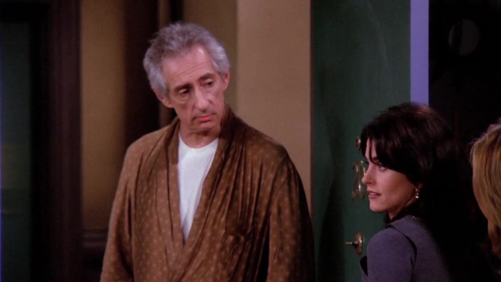 Mr. Heckles speaking to Monica and Rachel at their apartment door in Friends S01E16.