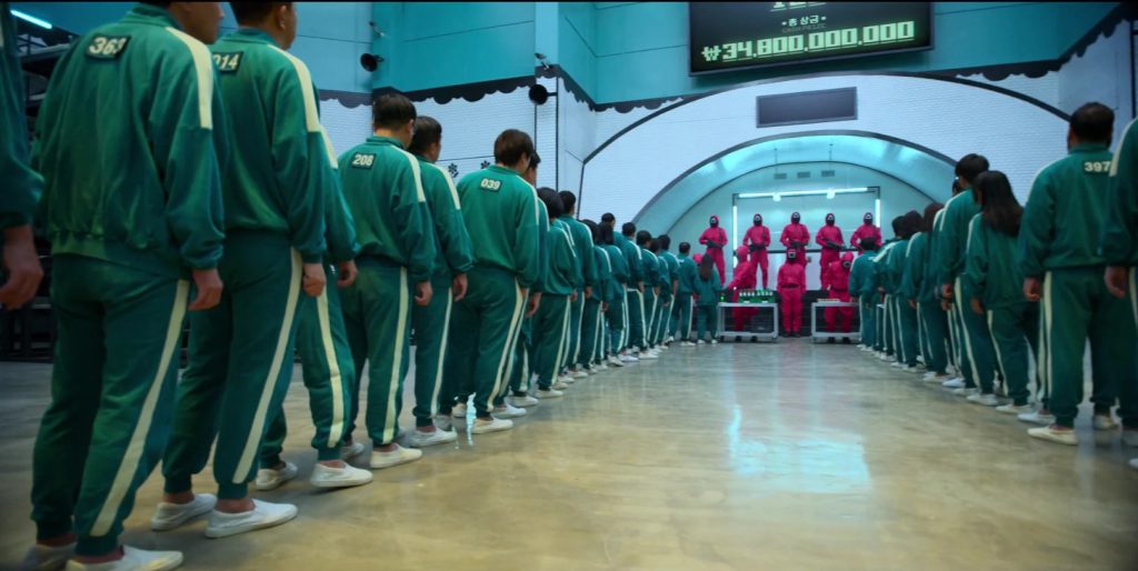 "A lineup of players in green tracksuits in Squid Game, great for learning competition and anticipation vocabulary."