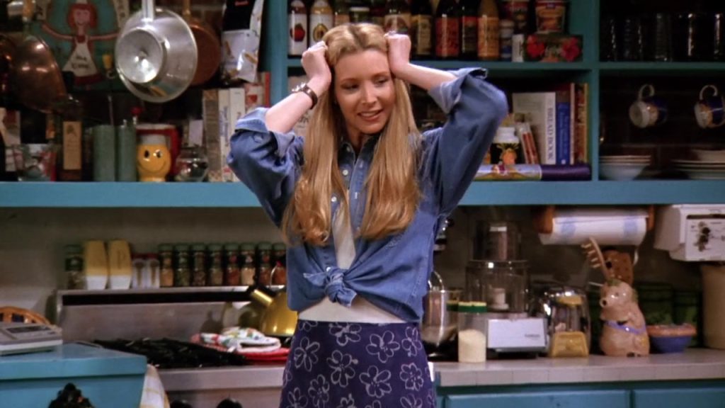 Phoebe smiling in Monica's kitchen from Friends Season 1 Episode 21