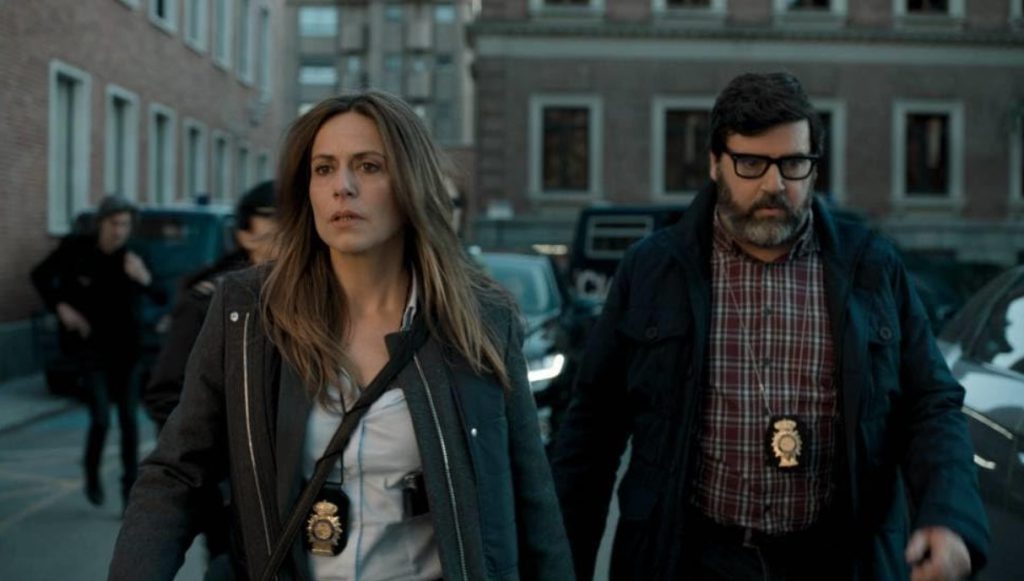 Police inspectors walking in action scene from Monet Heist.