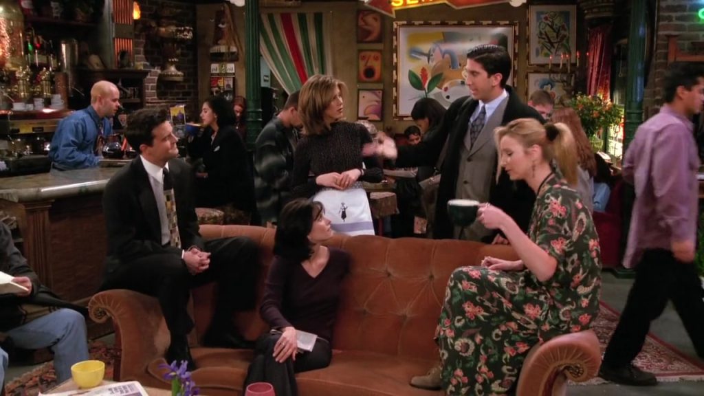 "Friends cast chatting in Central Perk, ideal scene for language study movies."