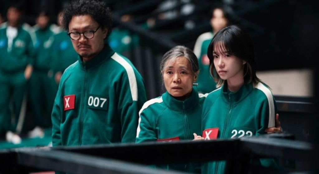 "Group of players in green uniforms during a critical moment in Squid Game – ideal for language learning with Netflix."