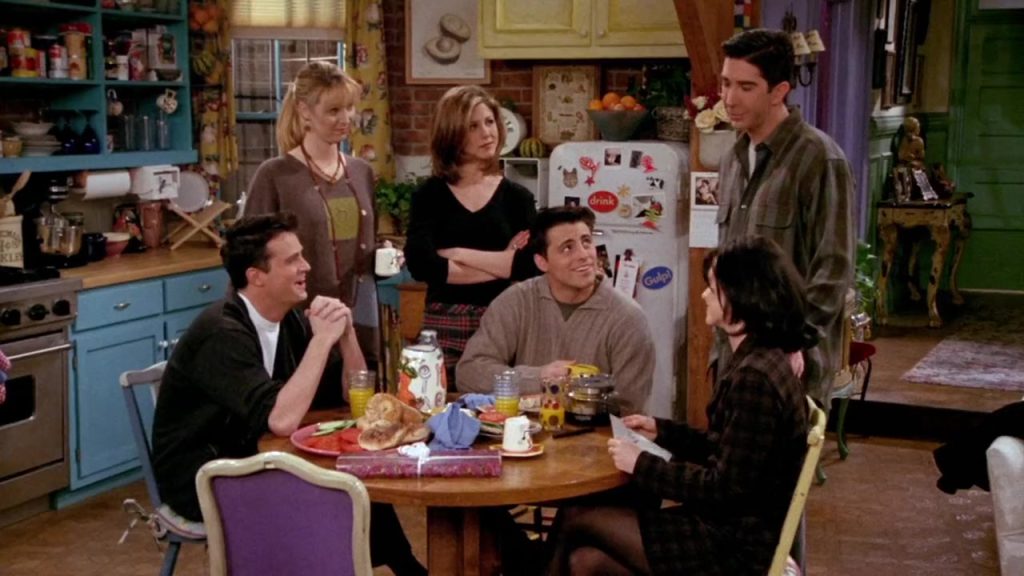 "Learn English with TV series - Friends group scene at the kitchen table." "Friends S02E16 cast gathered around the kitchen table learning English with TV series."