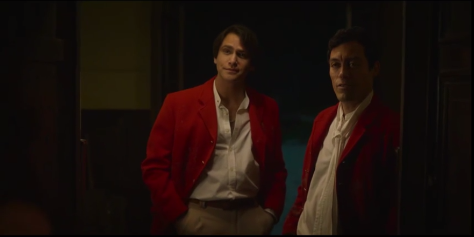 Two men in red jackets standing at a doorway, Film Vocabulary Builder scene