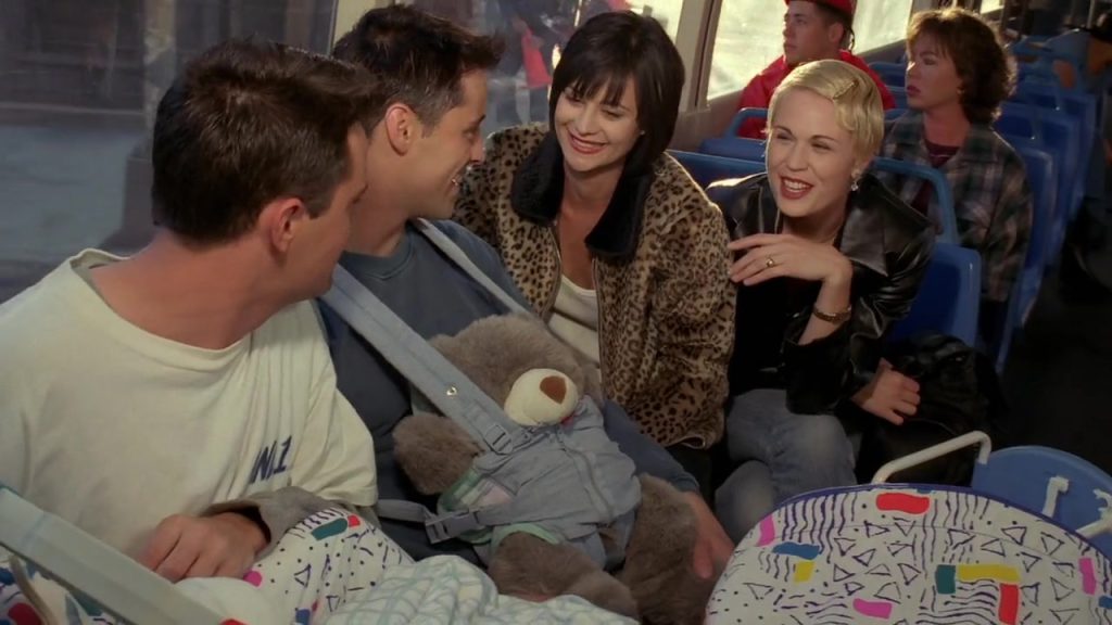 Chandler and Joey on the bus with two women and a baby in Friends S02E06