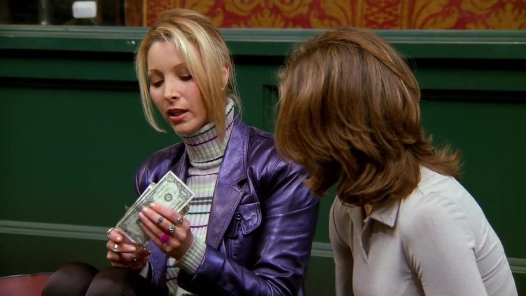 Phoebe counting money while Rachel looks on in Friends S02E06