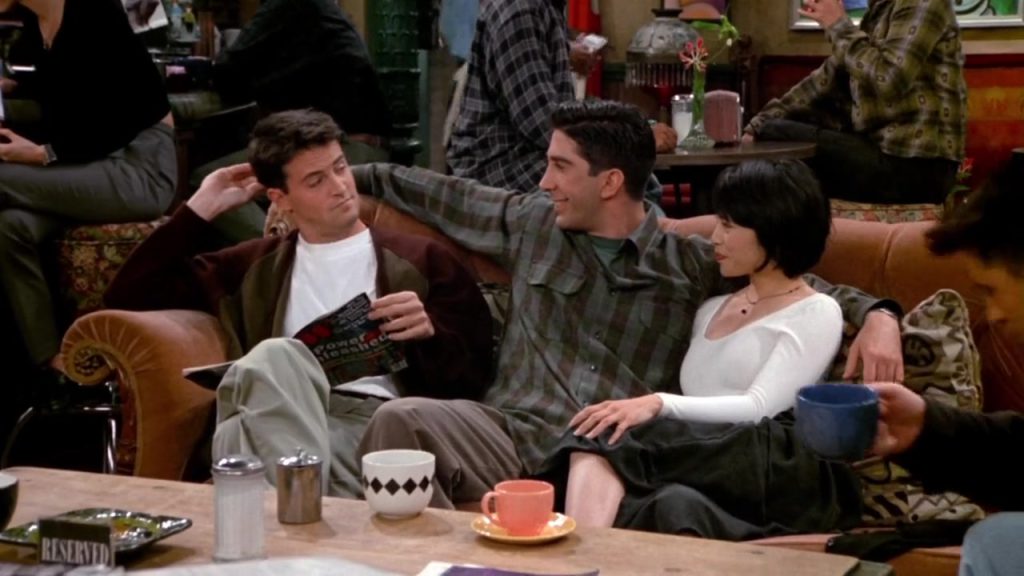 Friends cast sitting on a couch at Central Perk, perfect for language study movies