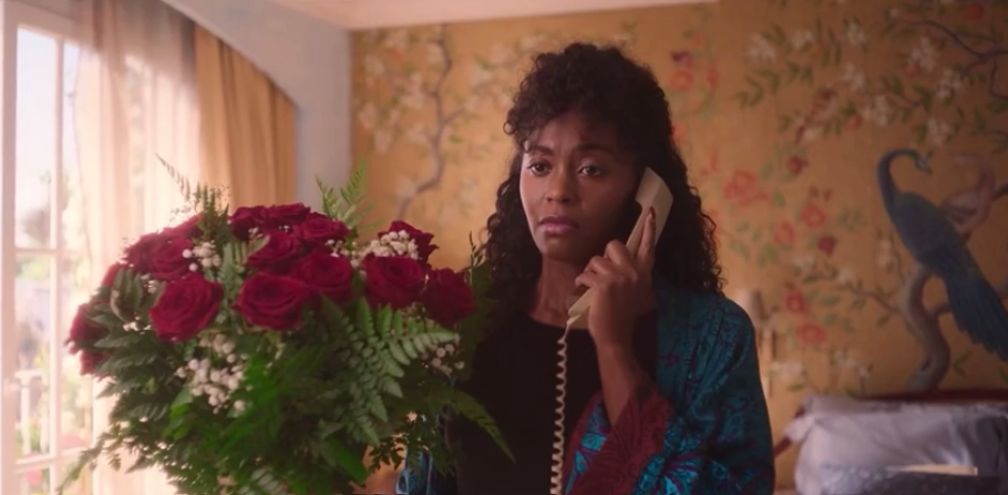 Woman holding a phone and a bouquet of roses during a tense conversation - Movie Language Practice scene